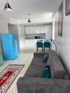 a living room with a couch and a kitchen at Lucky Number in Sinaia