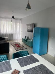 a living room with a blue refrigerator in a room at Lucky Number in Sinaia