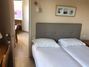 Ένα ή περισσότερα κρεβάτια σε δωμάτιο στο Contact Hotel LE SUD Montpellier Aéroport Parc Expo Arena