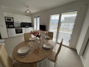 a kitchen and dining room with a wooden table and chairs at View Point Lake and Mountains in Annecy +12 photos