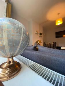 a globe sitting on top of a bed at 18K HOME FROM HOME in London