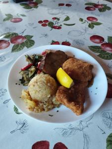 a plate of food with meat and vegetables on a table at Planinski dom Vrhe in Trbovlje