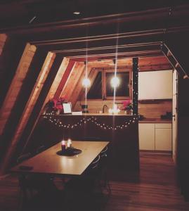 a room with a table and a kitchen with lights at Mesa Summer House in Zakrzewo