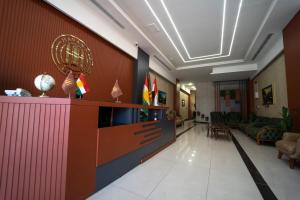 a lobby with a reception desk and a living room at Havana Hotel in Duhok