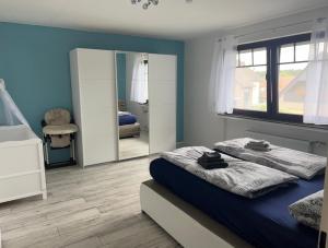文斯托夫的住宿－Fewo am Wald，一间卧室配有两张床和镜子