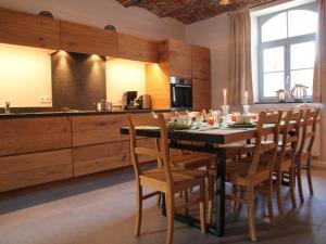 a kitchen with a dining room table and chairs at Situated in wonderful castle grounds in Gesves in Gesves