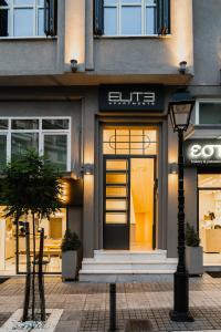 a store with a sign on the front of a building at ELITE APARTMENTS in Thessaloniki