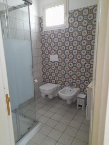 uma casa de banho com um WC, uma banheira e um lavatório. em Domus Veretum em Morciano di Leuca