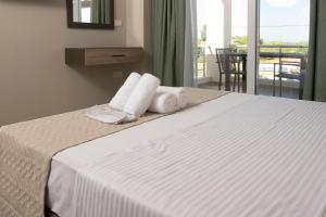 a hotel room with a bed with towels on it at Apanemo Kourouta Luxury Double Room in Kourouta