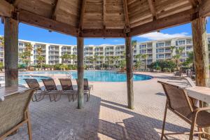 a resort with a swimming pool and a building at Crescent at Miramar 406 - Sheer Bliss in Destin