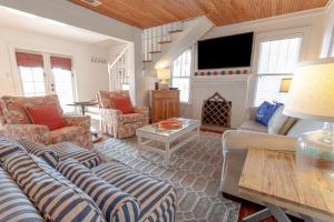 a living room with couches and a fire place at 19306 Front Beach Rd - Lagunas Little Cottage in Panama City Beach
