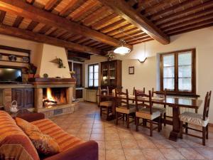 sala de estar con mesa y chimenea en Modern Holiday Home in Foiano della Chiana with Pool en Foiano della Chiana