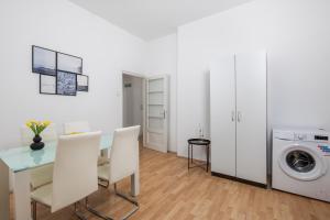 a living room with a table and a washing machine at Step to the Sea apartment in Rijeka