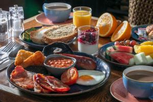 a table with a breakfast plate of eggs and toast at Birmingham North Moor Hall Hotel BW Premier Collection in Sutton Coldfield