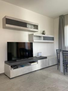 a living room with a large flat screen tv at Olbios Apartment in Olbia