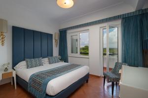 a bedroom with a king sized bed and a window at Hotel Oasi Di Kufra in Sabaudia