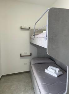 a bedroom with a bunk bed and a staircase at Olbios Apartment in Olbia