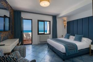 a bedroom with a bed and a view of the ocean at Hotel Oasi Di Kufra in Sabaudia