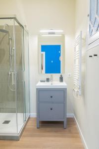 a bathroom with a sink and a shower at Aticco Living Gràcia - Apartments Rooftop in Barcelona