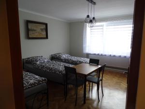a living room with a couch and a table at Mieszkania pracowniczo-turystyczne in Żelazna