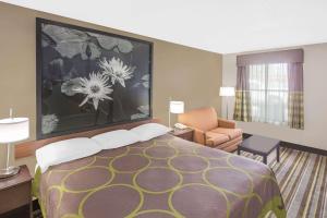 A bed or beds in a room at Super 8 by Wyndham Bay St. Louis