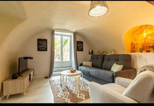 a living room with a couch and a table at Domaine luna estella in Tourrette-Levens