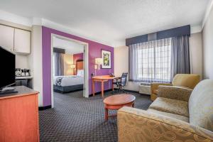 a hotel room with a bed and a living room at La Quinta by Wyndham Myrtle Beach Broadway Area in Myrtle Beach +22 photos