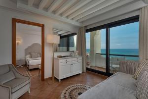 a living room with a view of the ocean at Hotel Oasi Di Kufra in Sabaudia