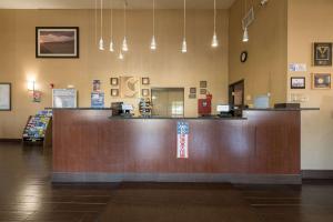 a lobby with a large wooden counter in a store at Comfort Inn & Suites Alamosa in Alamosa