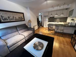 ein Wohnzimmer mit Sofa und Tisch in der Unterkunft Oktheway Santander Street 5 in A Coruña
