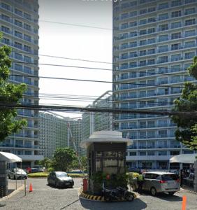 a city street with tall buildings in the background at SM Bicutan Affordable Rooms in Manila