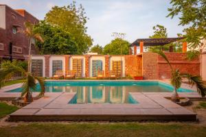 a swimming pool in the backyard of a house at Tree Of Life Bhadrajun House, Jodhpur in Jodhpur