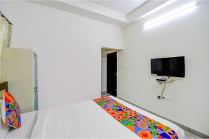 a bedroom with a bed with a colorful carpet at FabExpress Moon Residency in Kolkata