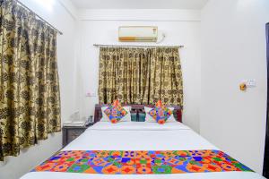 una camera con un letto con una coperta colorata di FabExpress Moon Residency a Calcutta