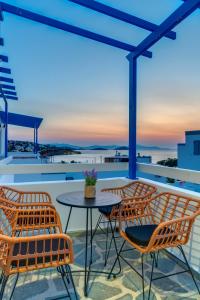 a patio with a table and chairs on a roof at Armenaki in Azolimnos Syros
