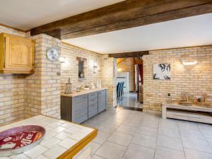 a kitchen with brick walls and a counter top at Beautiful Holiday Home in Cul des Sarts with Garden in Cul-des-Sarts