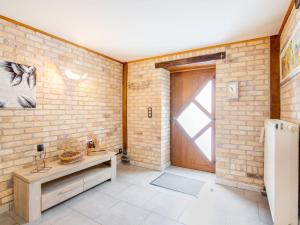 a room with a brick wall and a door at Beautiful Holiday Home in Cul des Sarts with Garden in Cul-des-Sarts