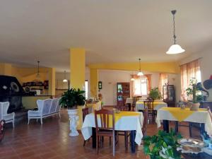 una sala da pranzo con tavoli bianchi e sedie bianche di Casale 920 ad Agropoli