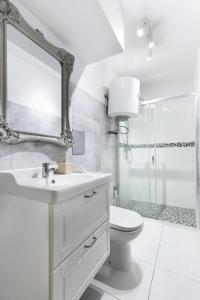 a bathroom with a sink and a toilet and a shower at Elite Apartments Center Superior in Gdańsk