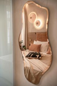 a mirror reflecting a bed in a bedroom at Casa Modiano Boutique in Chania