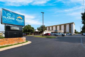 a sign in a parking lot in front of a building at Clarion Hotel San Angelo near Convention Center in San Angelo