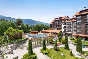 a resort with a pool and mountains in the background at The Balkan Jewel Resort, Trademark Collection by Wyndham in Bansko