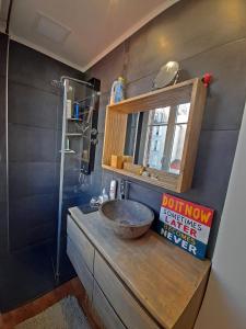 a bathroom with a sink with a mirror and a shower at Très beau 2P avec vaste séjour ensoleillé - A 50 m du métro du marché et de la mairie in Clichy