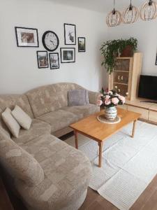 a living room with a couch and a coffee table at Apartmán Zelenka in Železná Ruda