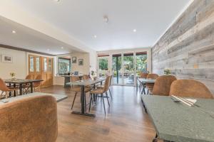 a restaurant with tables and chairs in a room at Meadowdore Stay B&B in Coniston