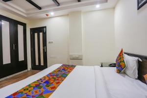 Postel nebo postele na pokoji v ubytování FabHotel Blue Moon Home Stay
