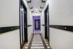 a hallway with a purple door and a tile floor at FabHotel Blue Moon Home Stay in New Delhi