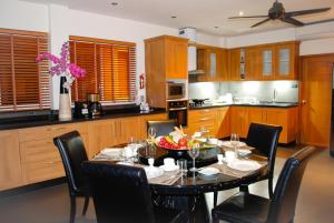 a kitchen with a table with chairs and a dining room at IslandView Villa in Choeng Mon Beach