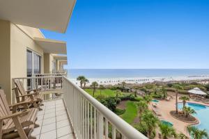 a view of the beach from the balcony of a resort at Crescent at Miramar 406 - Sheer Bliss in Destin