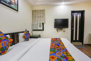 Postel nebo postele na pokoji v ubytování FabHotel Blue Moon Home Stay